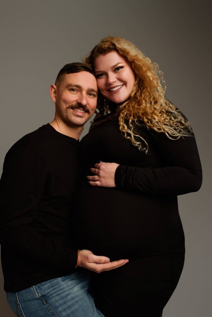 a husband and wife poses during their Columbus Ohio Maternity Photoshoot