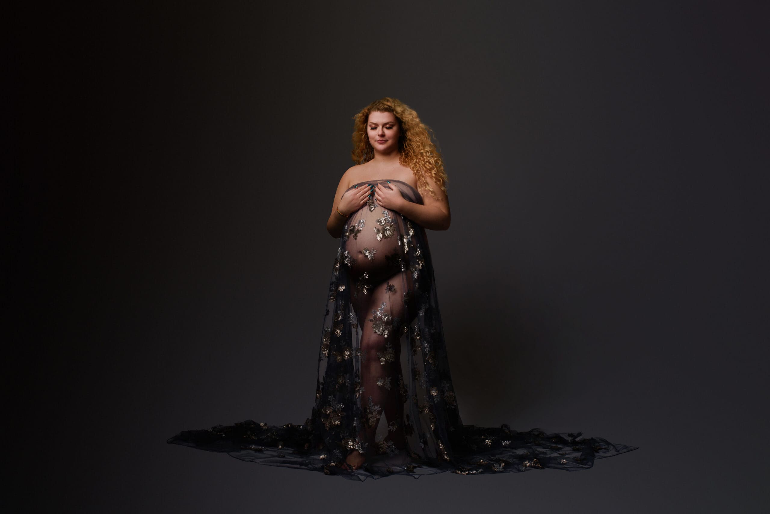 columbus ohio photo studio captures a maternity image with a woman in a sheer draping