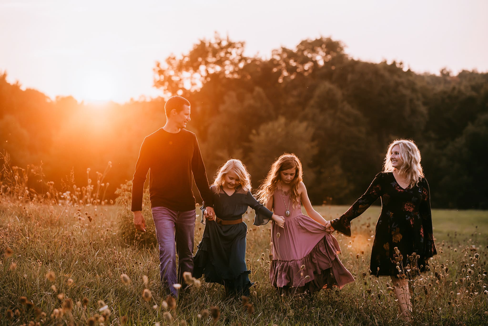 columbus ohio family photographer 7 family of four walking holding hands in sunset golden light
