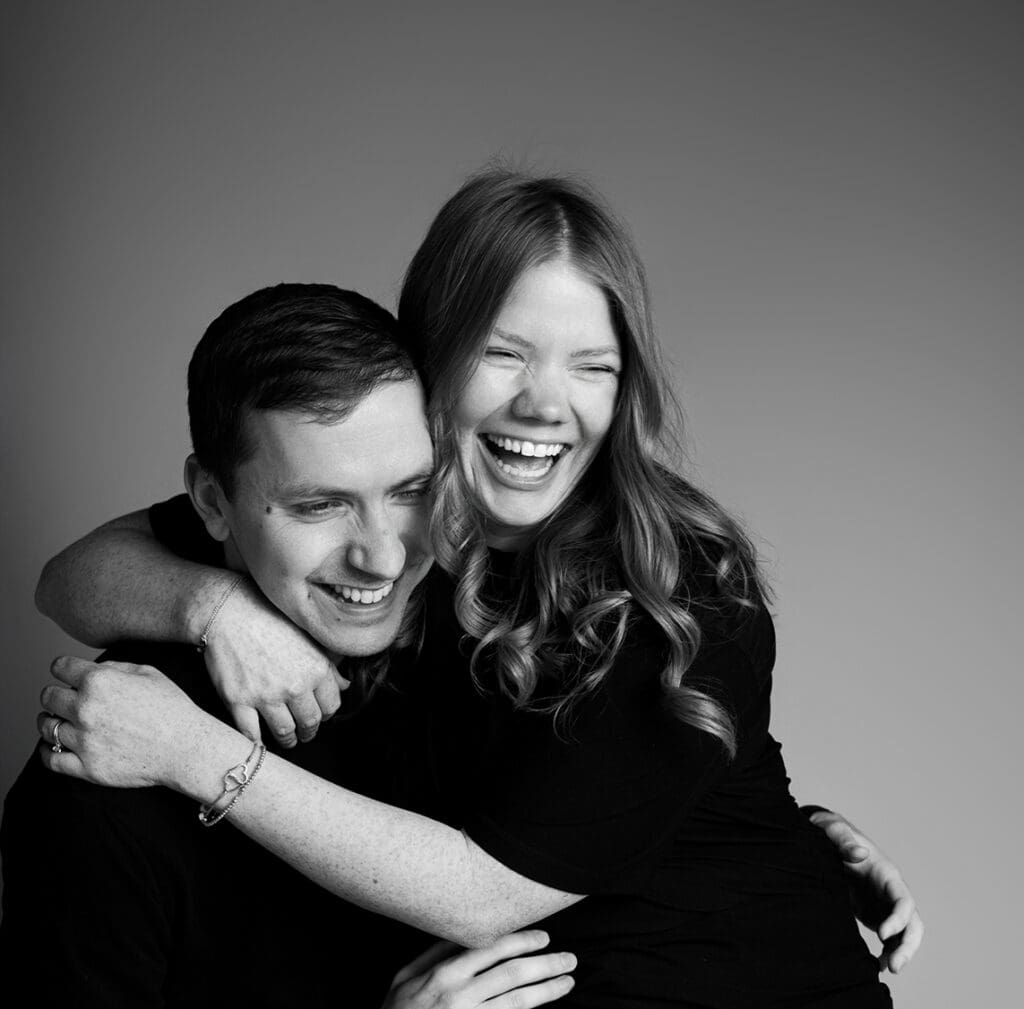 columbus-ohio-family-photographer black and white photo of husband and wife hugging and laughing together