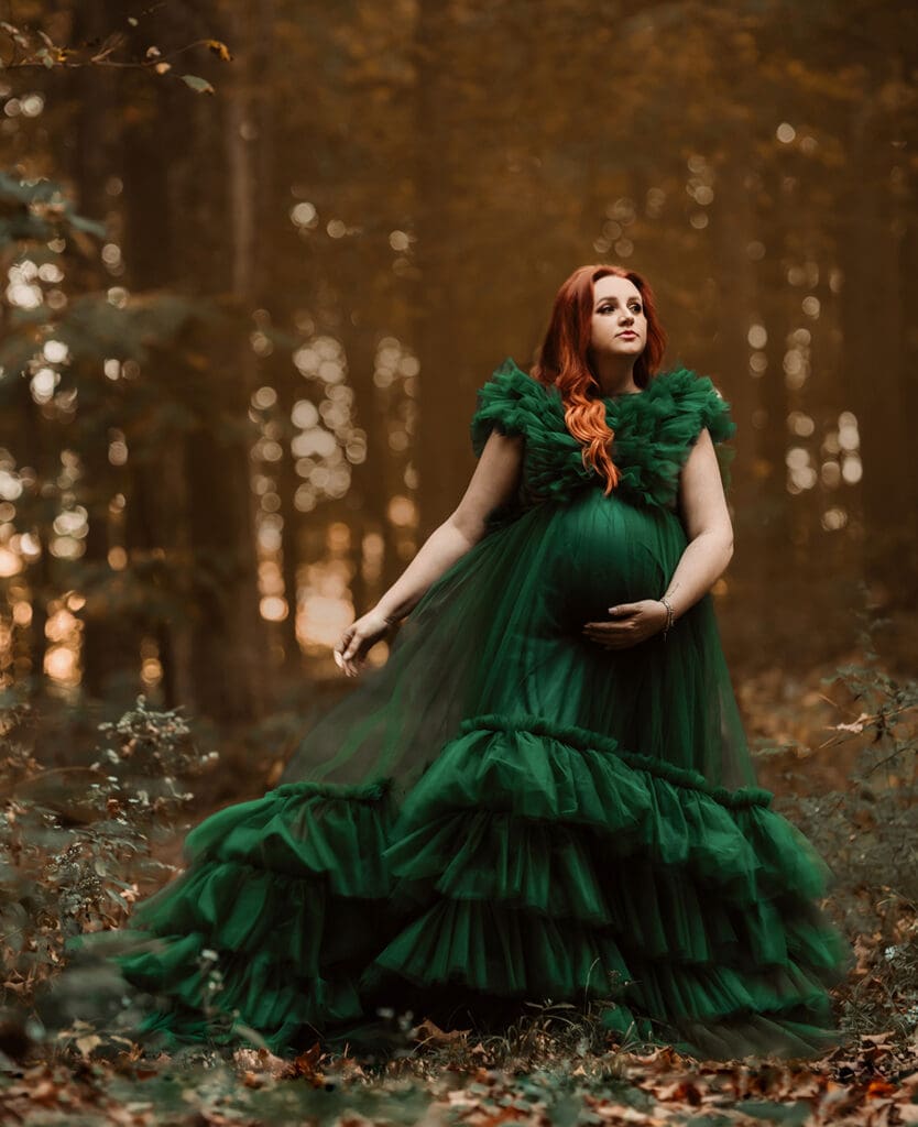 homepage columbus ohio photographer 3 woodland maternity session with pregnant woman in emerald dress staring off into the distance